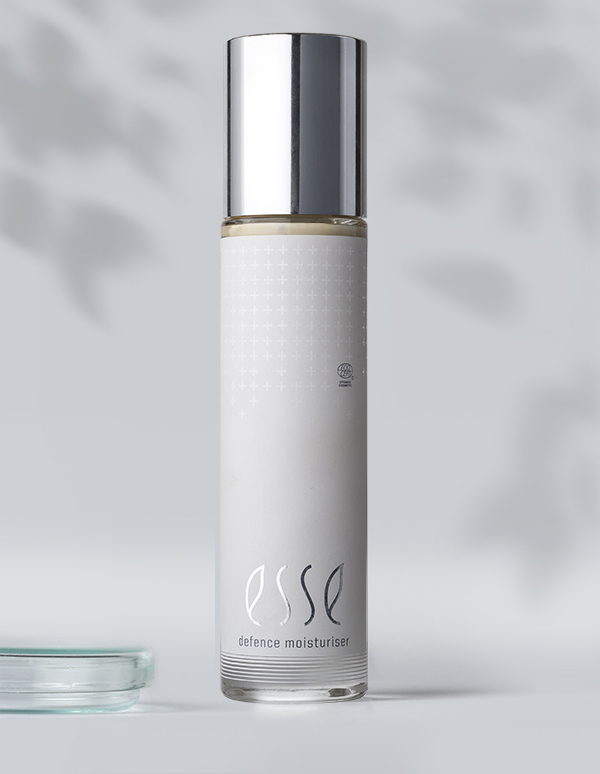 The Esse Defence Moisturiser features a sleek white bottle with a silver cap and minimalist design, standing upright against a softly blurred background.