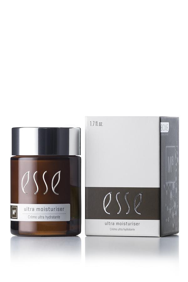 A brown jar with a silver lid labeled "Esse Ultra Moisturiser" is placed next to its white rectangular box with the same labeling. The jar holds 1.7 fl. oz. of product.