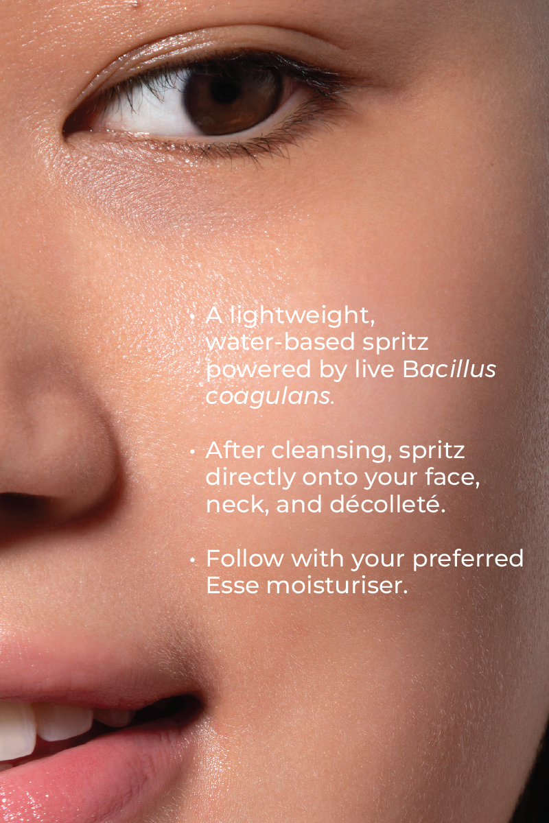 Close-up of a smiling face, focusing on a closed eye and cheek. Skincare instructions overlay: Apply lightweight, water-based Live Probiotic Mist with Bacillus coagulans, then follow with Esse moisturizer.